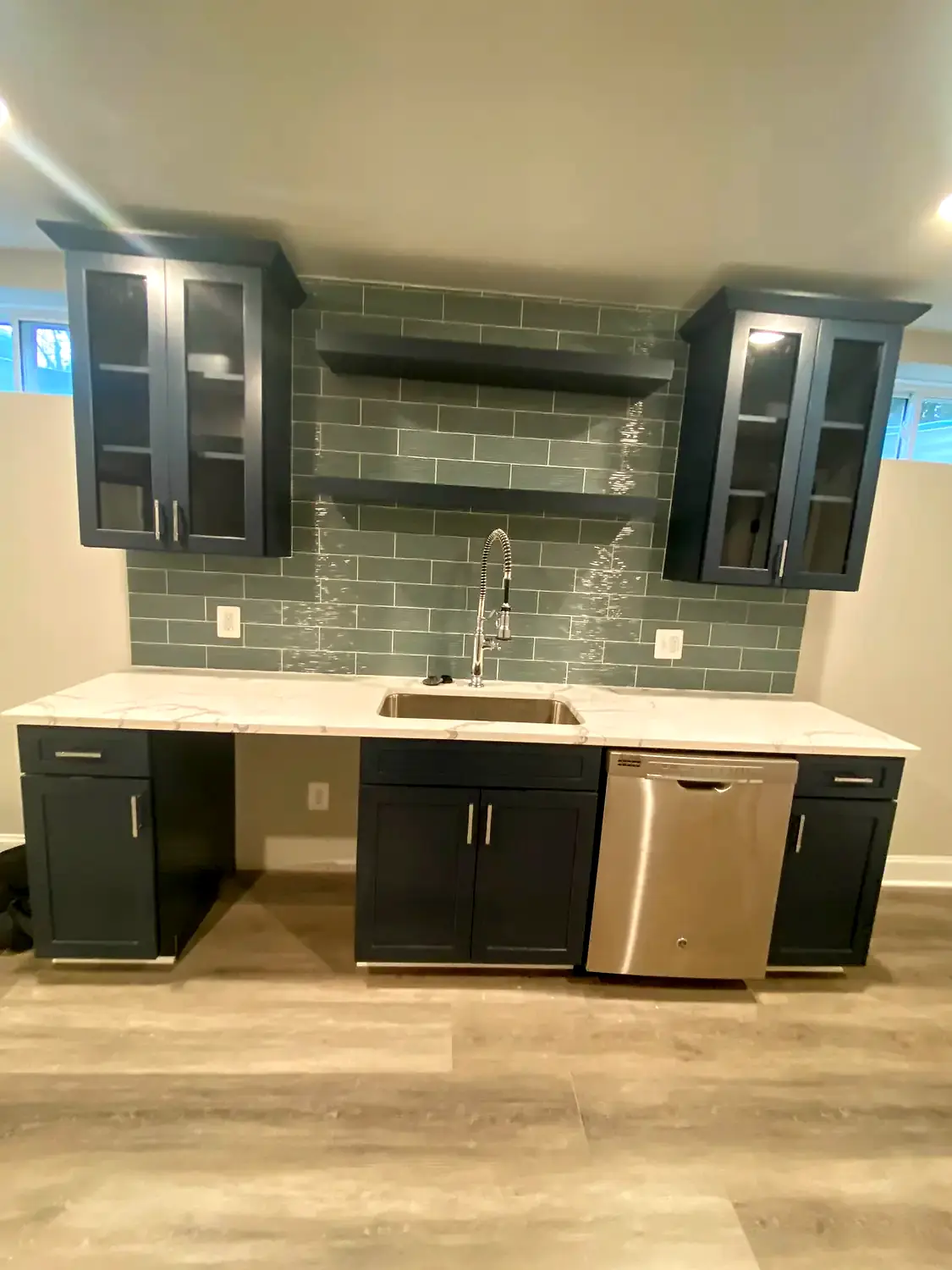 Media built-ins, flooring and stairs, basement finishing project in Northern Virginia by HOM Design & Build, view 1