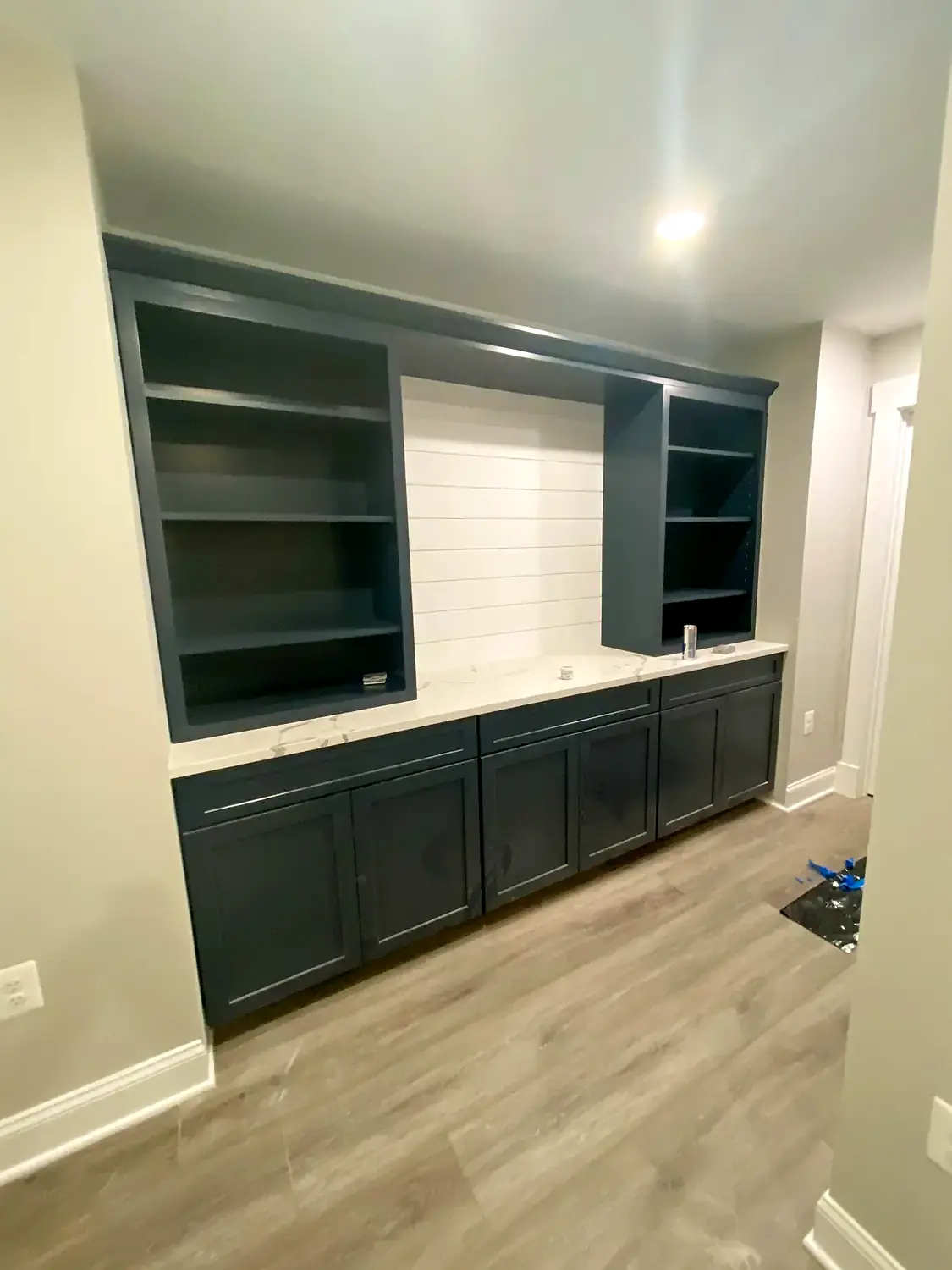 Media built-ins, flooring and stairs, basement finishing project in Northern Virginia by HOM Design & Build, view 2
