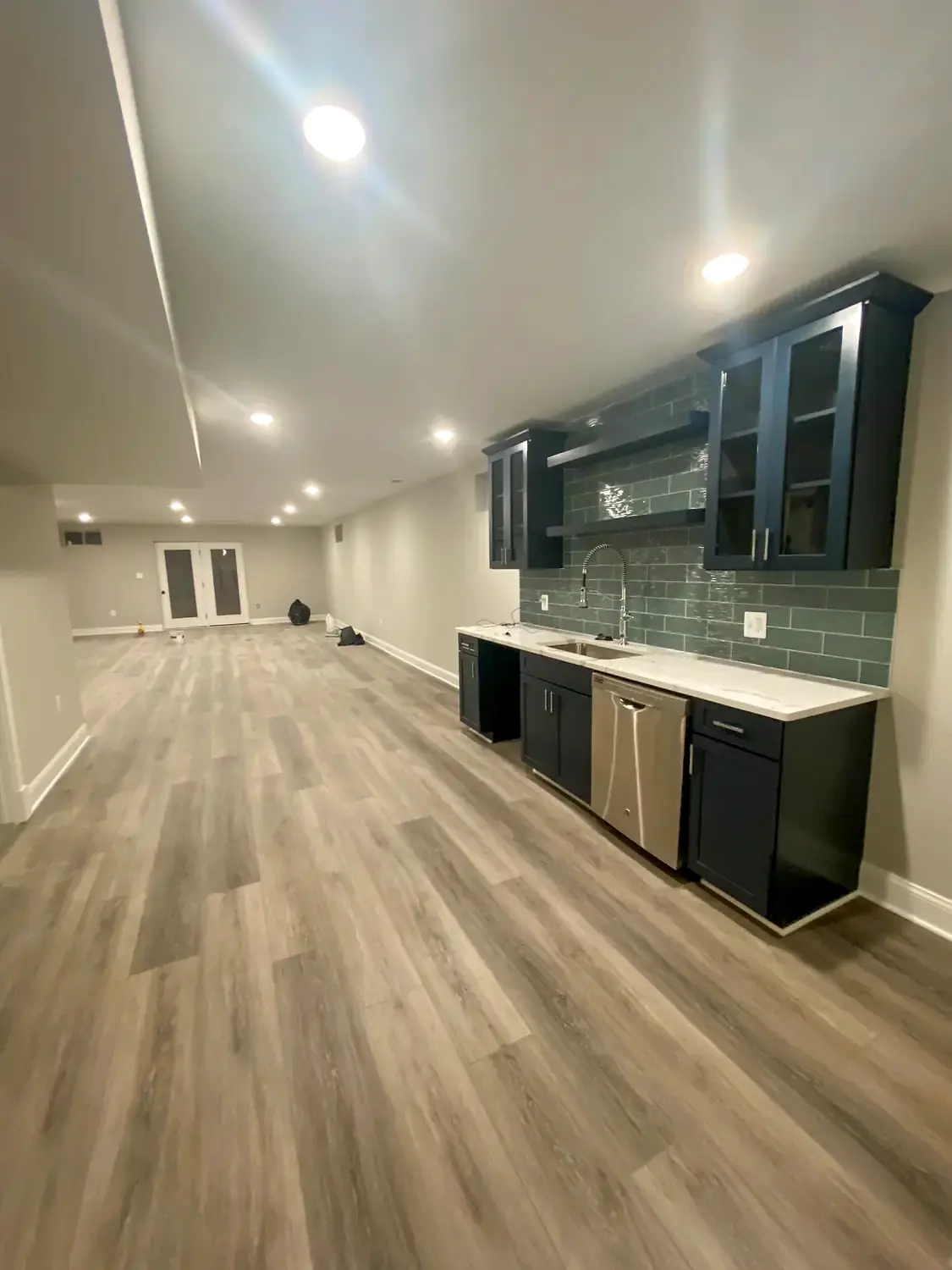 Media built-ins, flooring and stairs, basement finishing project in Northern Virginia by HOM Design & Build, view 3