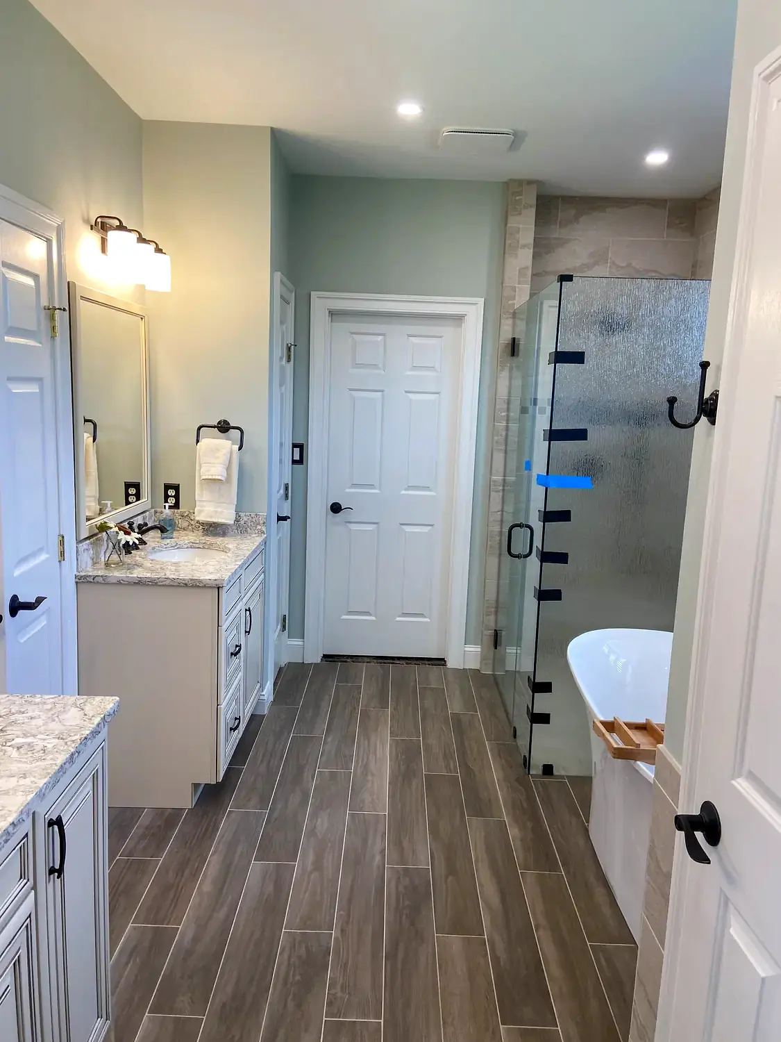 Glass shower and freestanding tub, bathroom remodeling project in Northern Virginia by HOM Design & Build, view 5