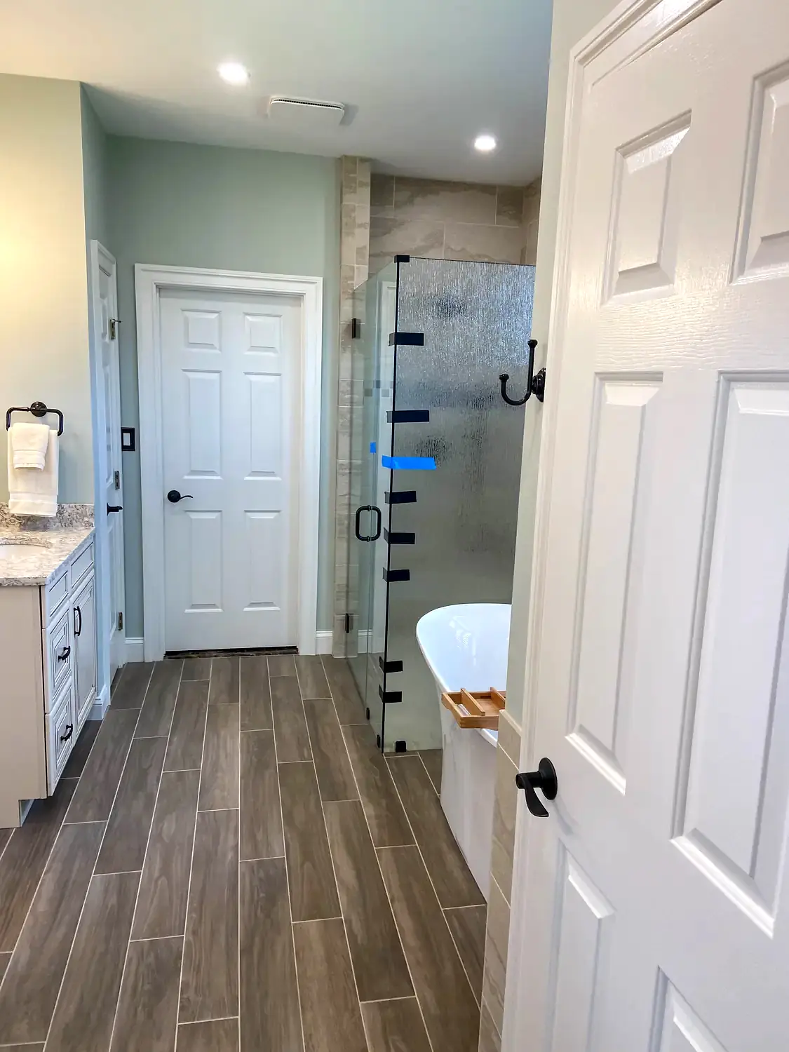 Glass shower and freestanding tub, bathroom remodeling project in Northern Virginia by HOM Design & Build, view 6