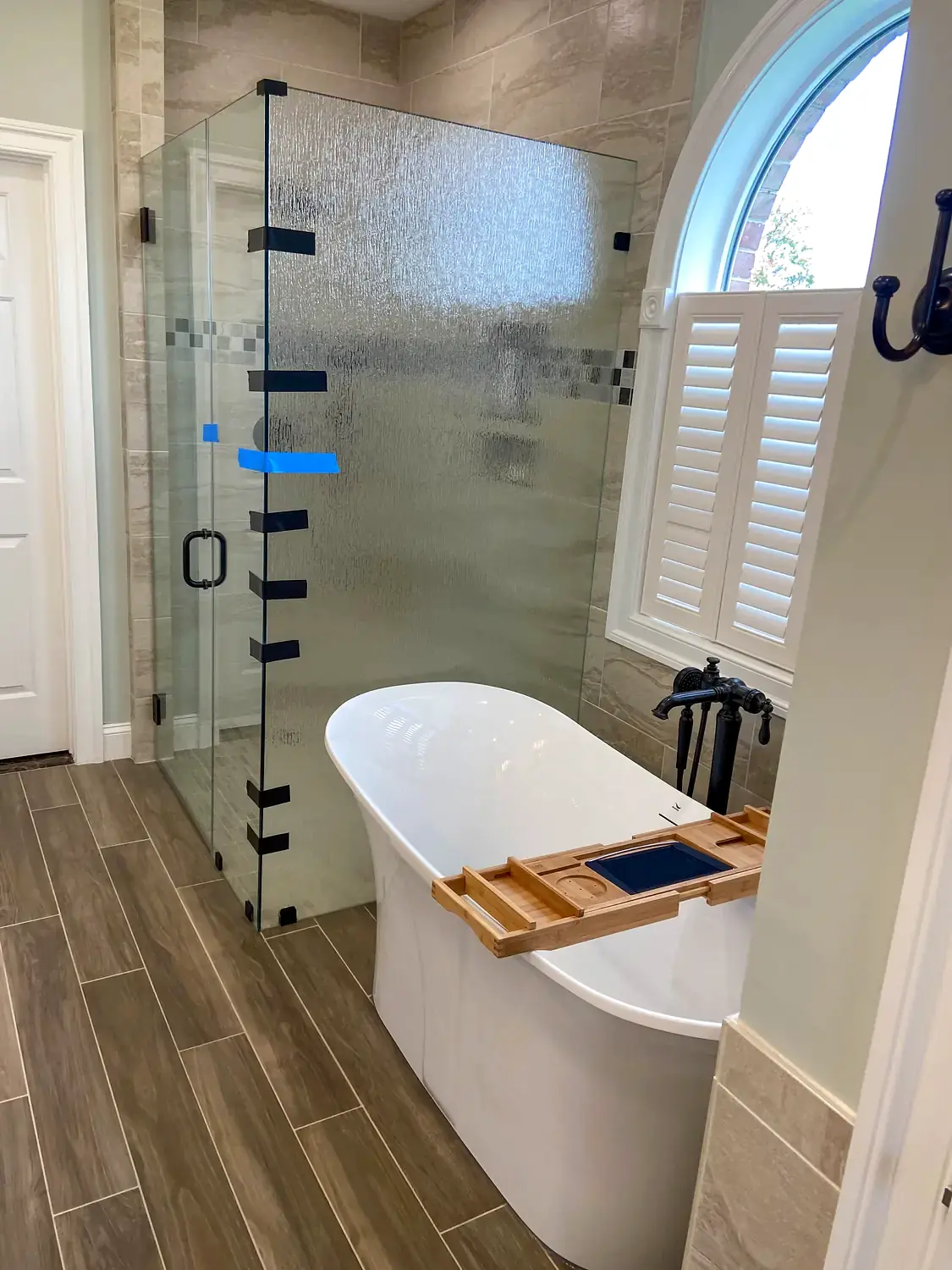 Glass shower and freestanding tub, bathroom remodeling project in Northern Virginia by HOM Design & Build, view 7