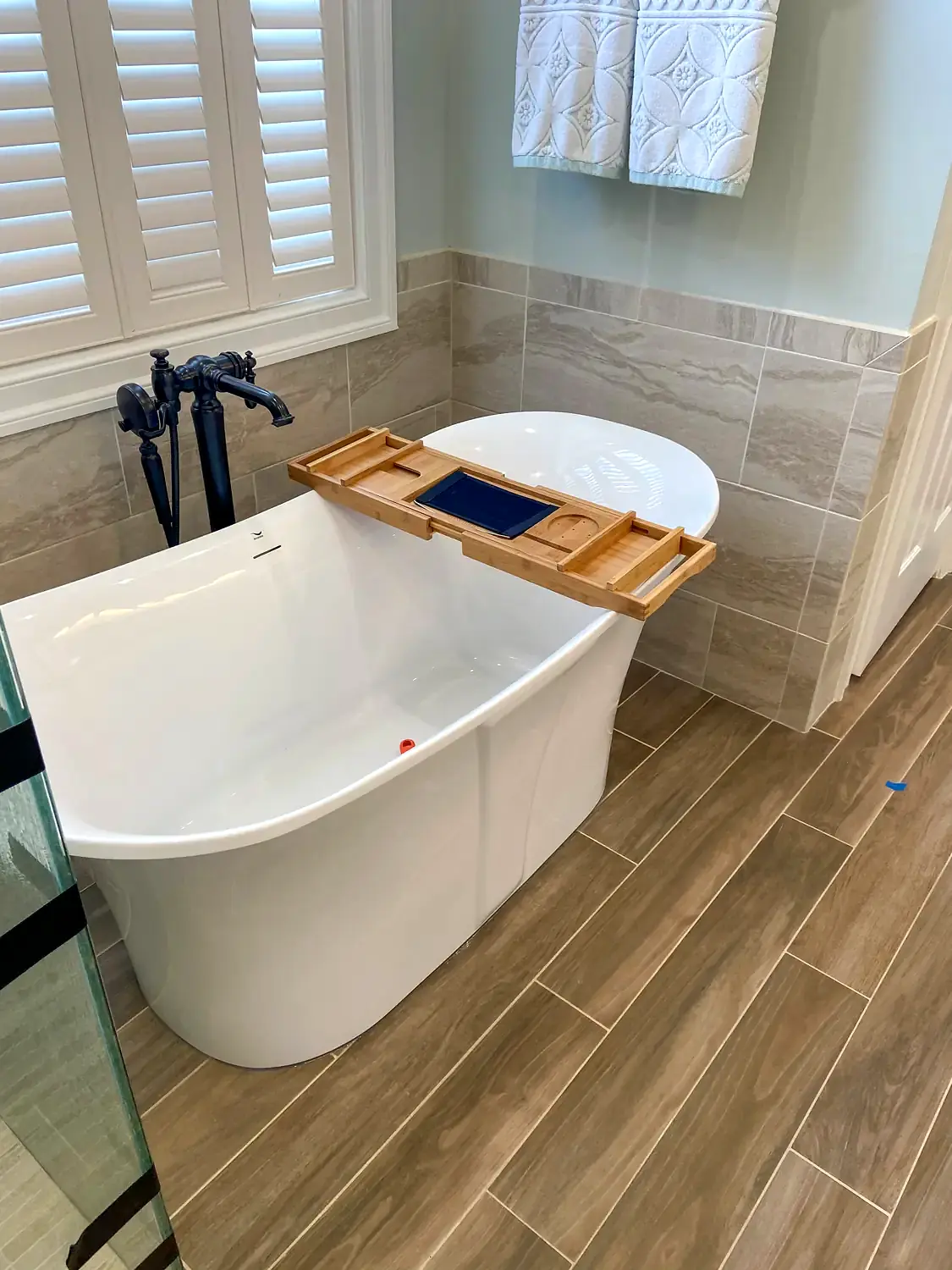 Glass shower and freestanding tub, bathroom remodeling project in Northern Virginia by HOM Design & Build, view 9