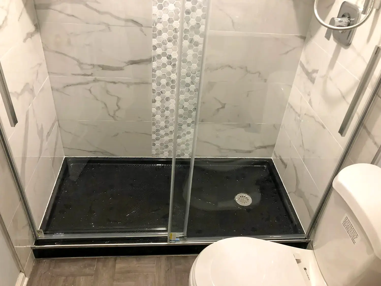 Marble-look walk-in shower, bathroom remodeling project in Northern Virginia by HOM Design & Build, view 1