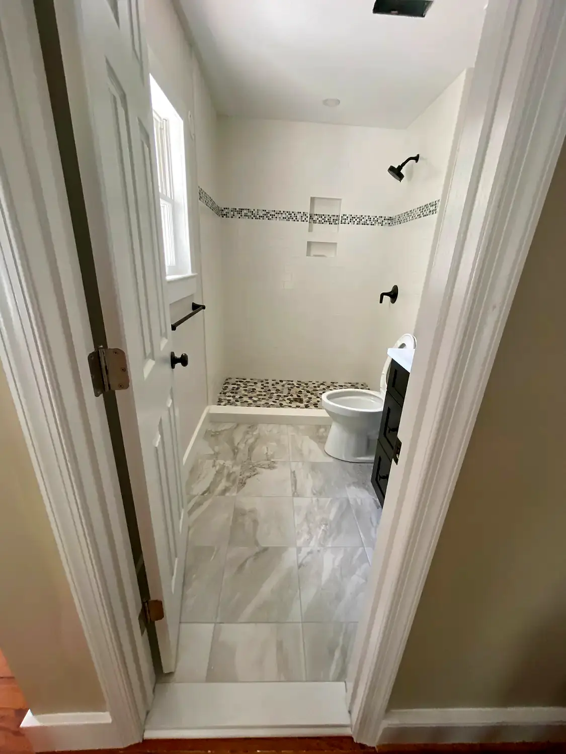 Compact marble bathroom, bathroom remodeling project in Northern Virginia by HOM Design & Build, view 2