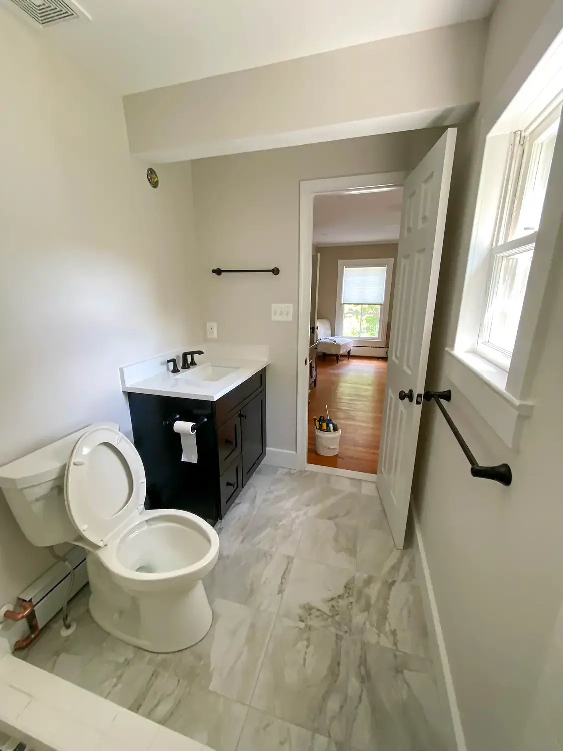 Compact marble bathroom, bathroom remodeling project in Northern Virginia by HOM Design & Build, view 3