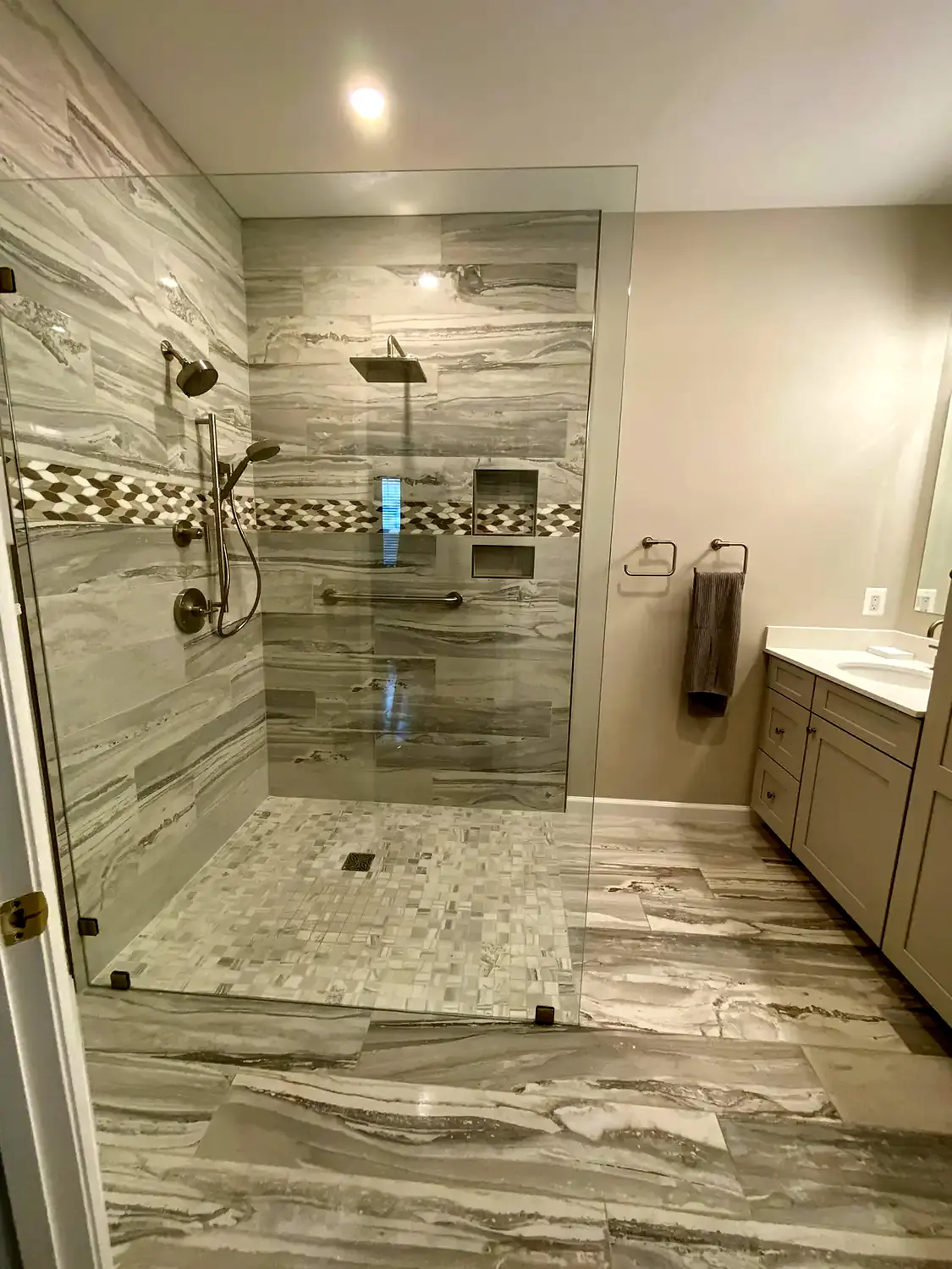 Large-format marble shower, bathroom remodeling project in Northern Virginia by HOM Design & Build, view 1