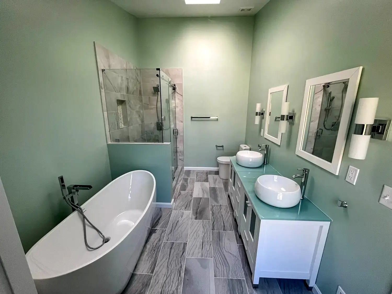 Green primary bathroom, bathroom remodeling project in Northern Virginia by HOM Design & Build, view 1