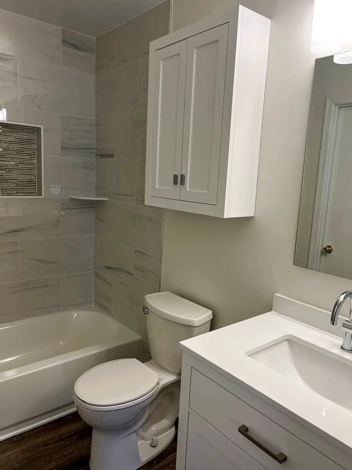 Bright tub-shower bathroom, bathroom remodeling project in Northern Virginia by HOM Design & Build, view 2