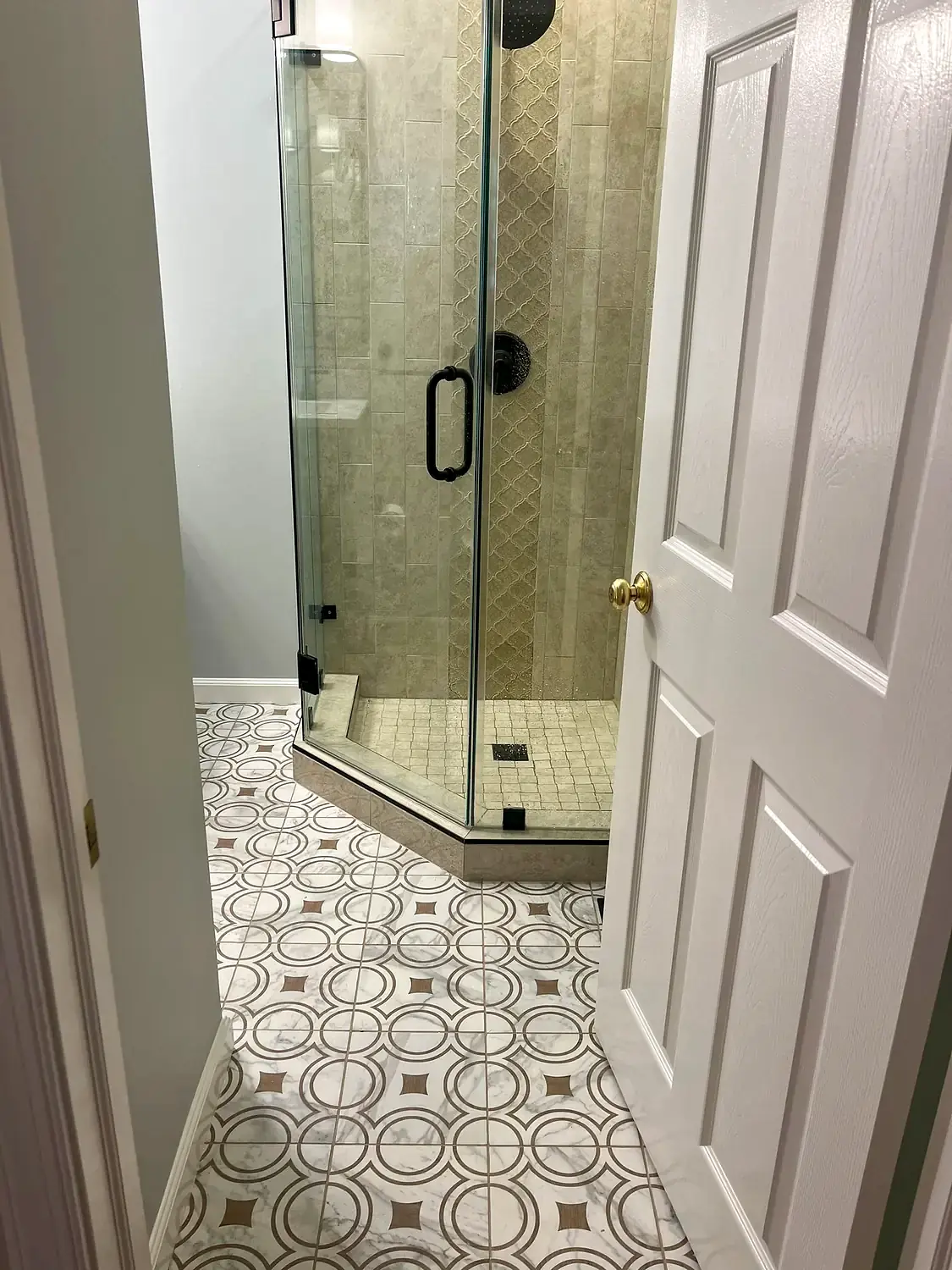Patterned-floor glass shower, bathroom remodeling project in Northern Virginia by HOM Design & Build, view 1