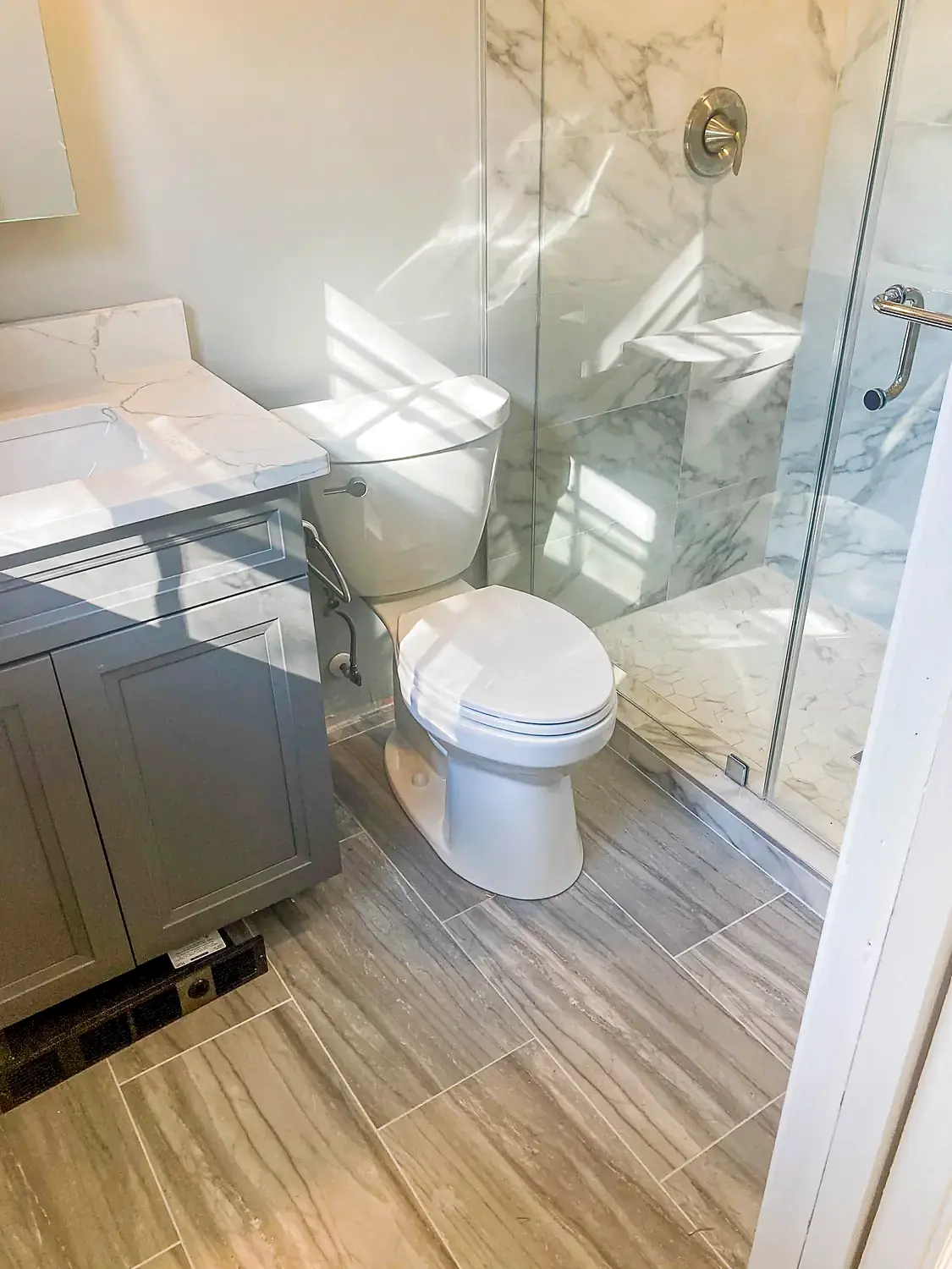Marble corner shower, bathroom remodeling project in Northern Virginia by HOM Design & Build, view 3
