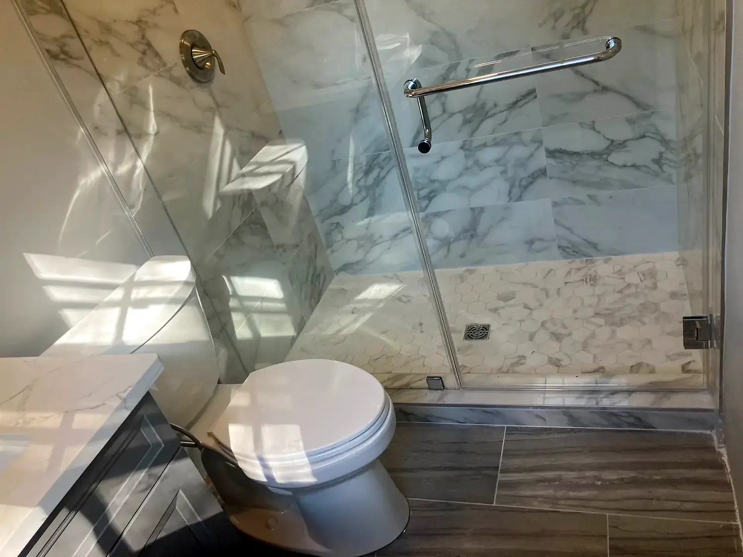 Marble corner shower, bathroom remodeling project in Northern Virginia by HOM Design & Build, view 5