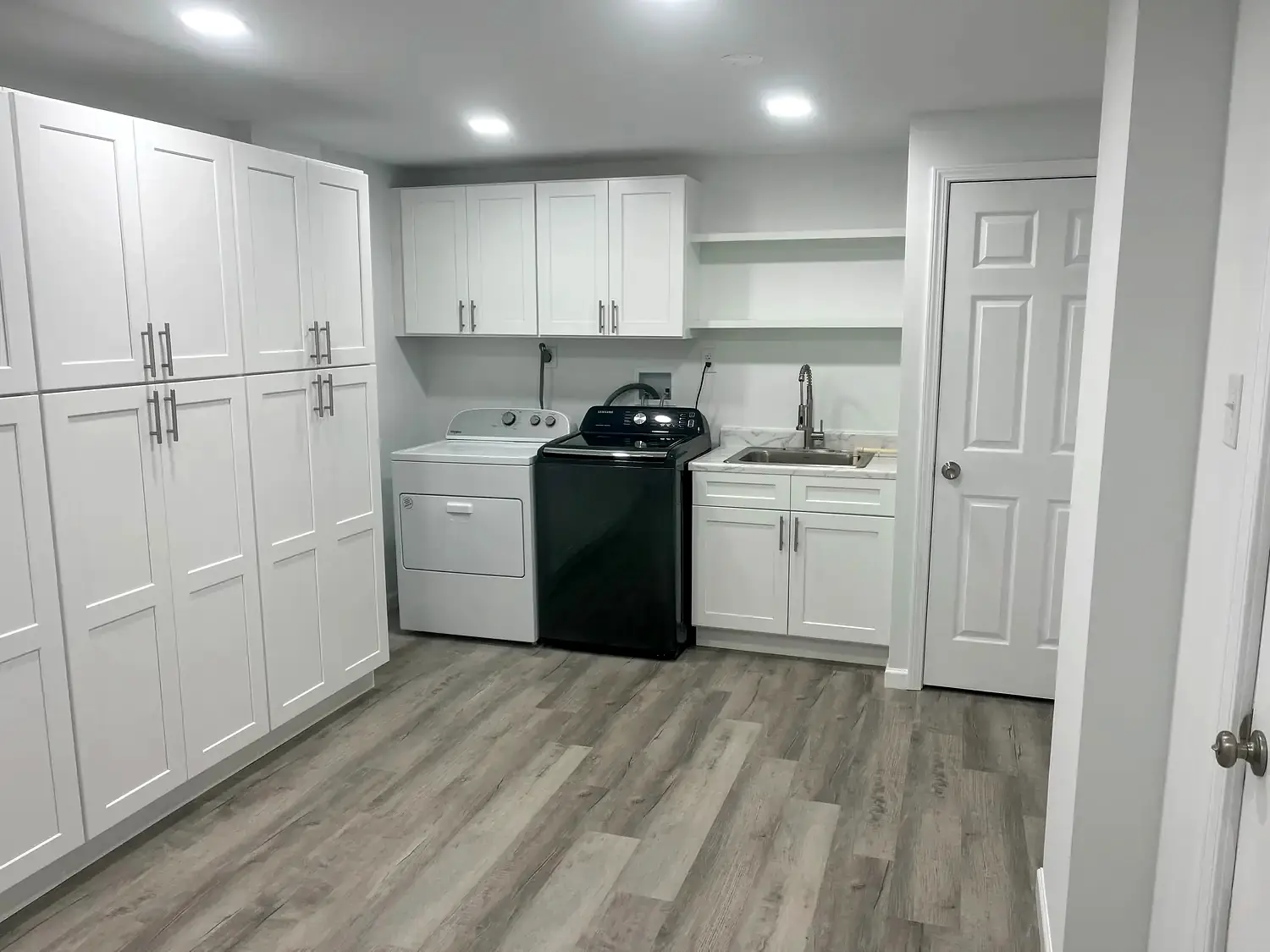 Laundry and storage room, whole-home remodeling project in Northern Virginia by HOM Design & Build, view 1