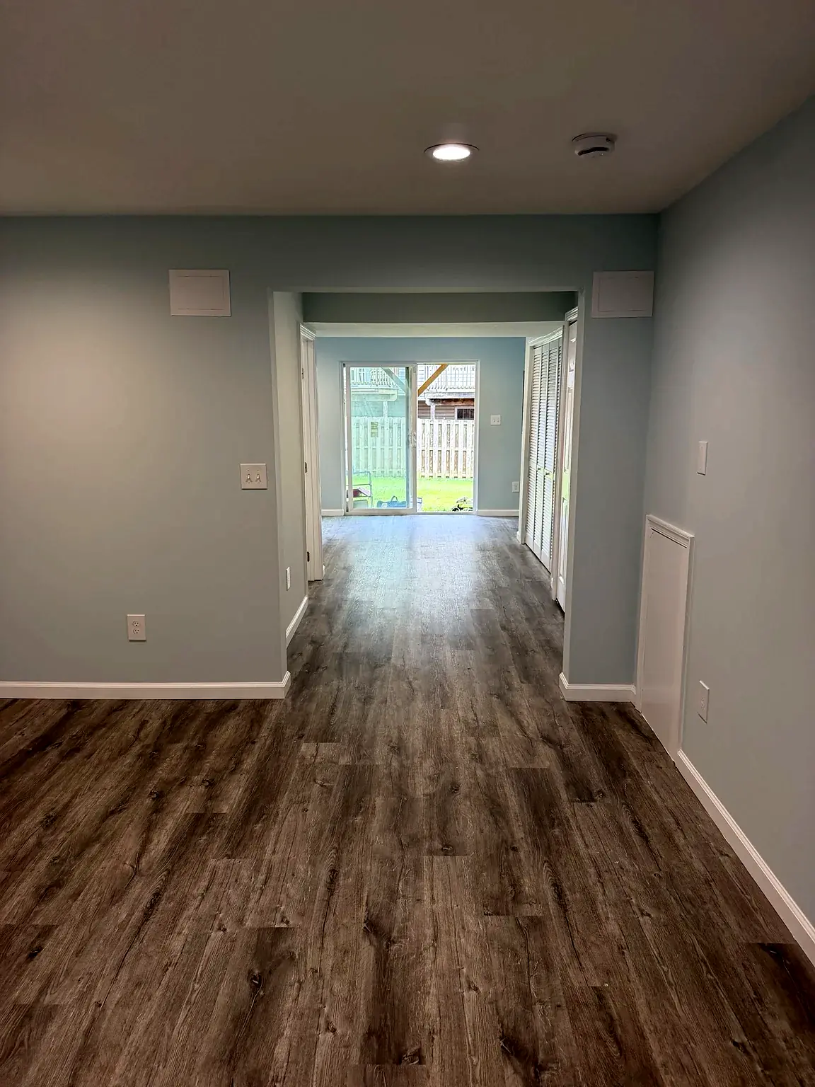 Finished lower-level rooms connected by a trimmed opening in Prince William Commons, Woodbridge, Virginia