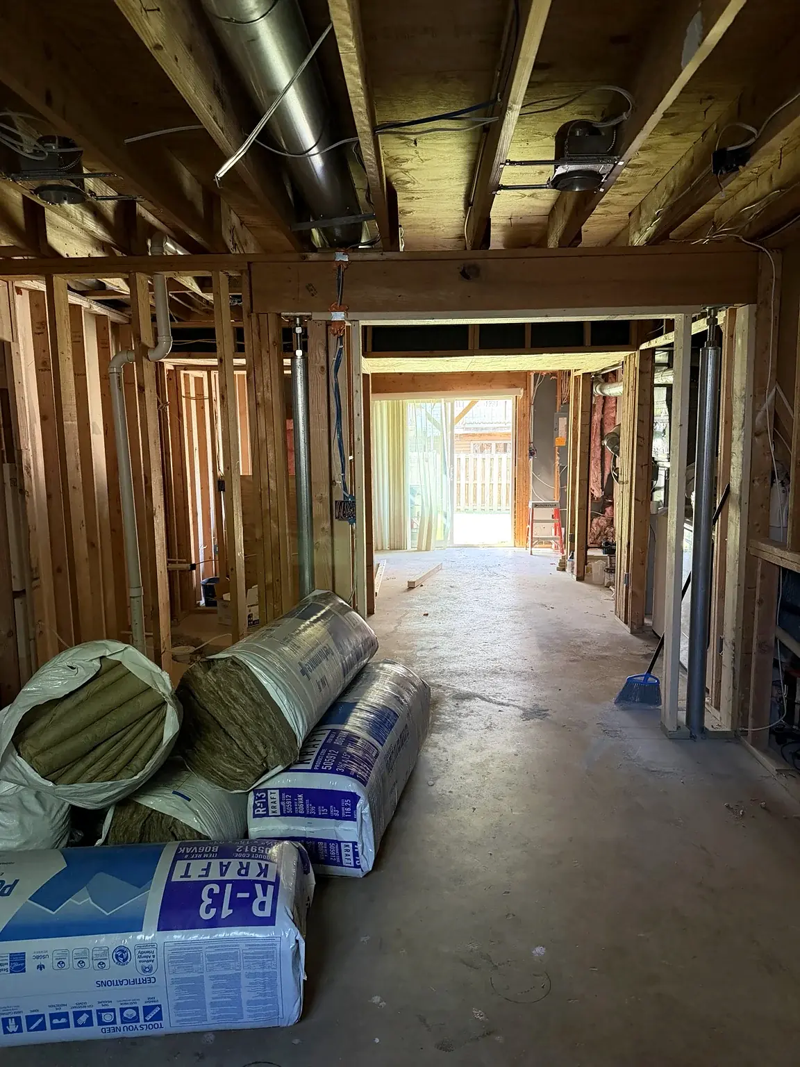 Basement framing looking toward the rear exterior door in Prince William Commons, Woodbridge, Virginia