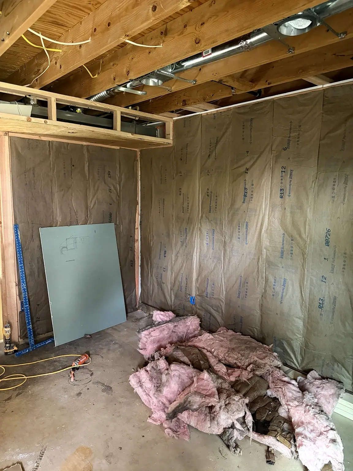 Insulation installed between basement wall studs in Prince William Commons, Woodbridge, Virginia