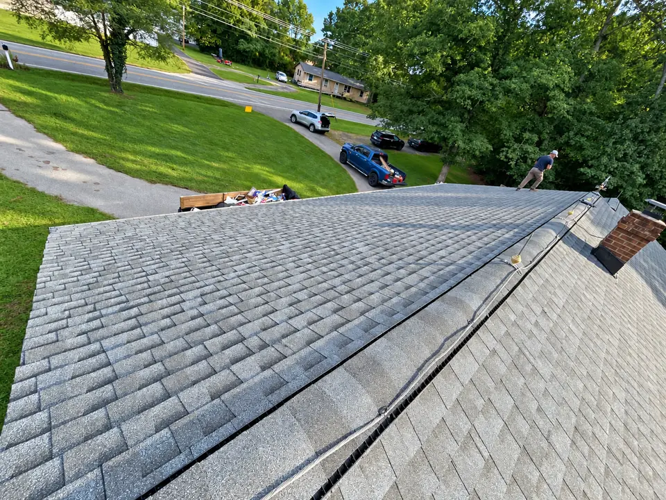 Front roof slope covered with gray shingles, with ridge detailing in the foreground